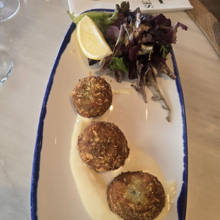 Photo credit: Karine Laudort Crab Cakes on mix leaves and citrus mayo